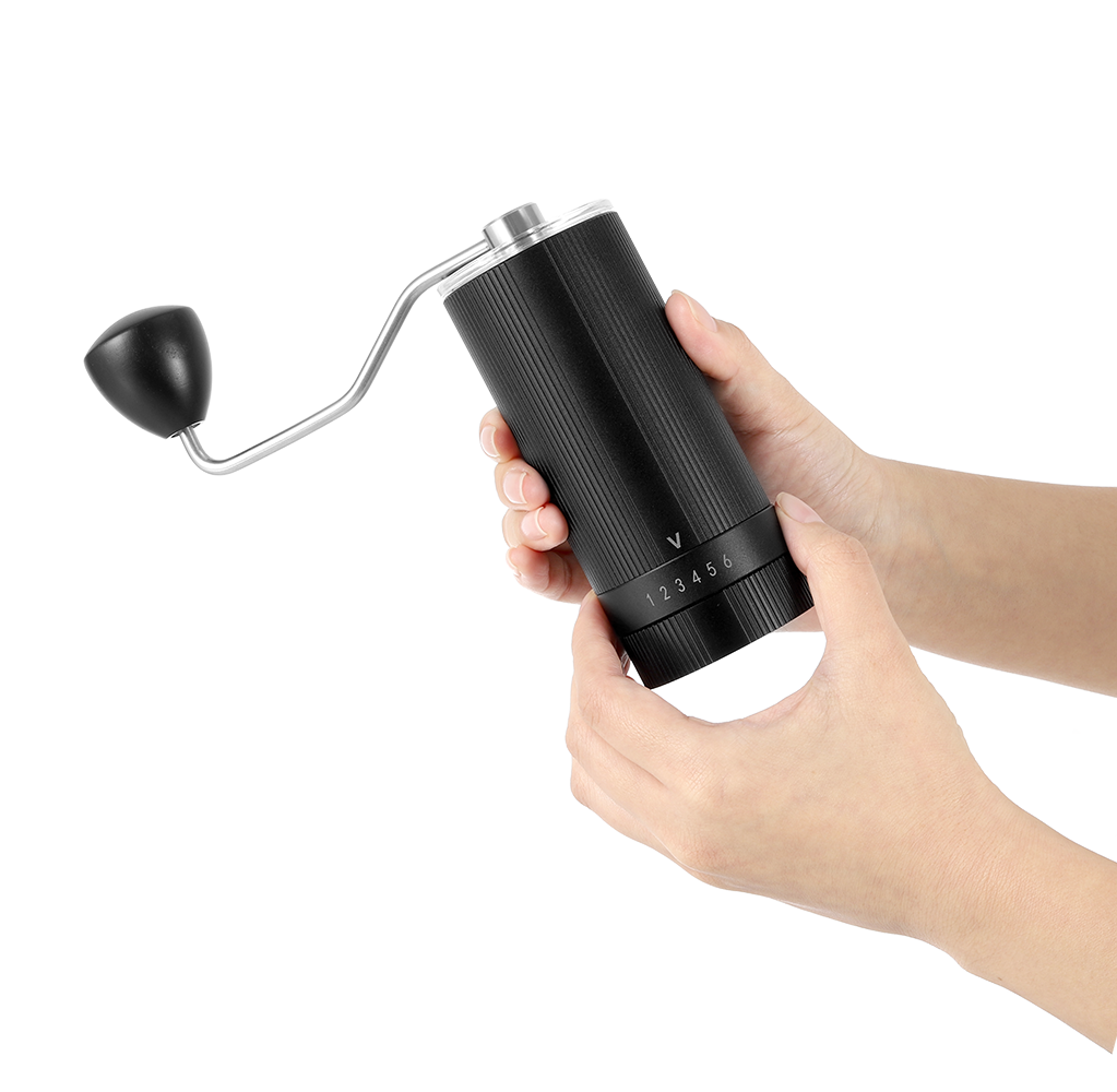 A pair of hands adjusting the coarseness ring on the VEVOK CHEF O6 Slim Glass Manual Coffee Grinder, showcasing its intuitive and user-friendly operation.