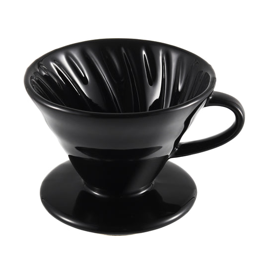 Close-up from a 45-degree angle showing the interior spiral ridges of the NERA Ceramic V-Shaped Pour Over Coffee Dripper. The unique ridges enhance the coffee extraction for a smooth, well-balanced flavor. VEVOK CHEF’s precision design guarantees perfect brewing every time.